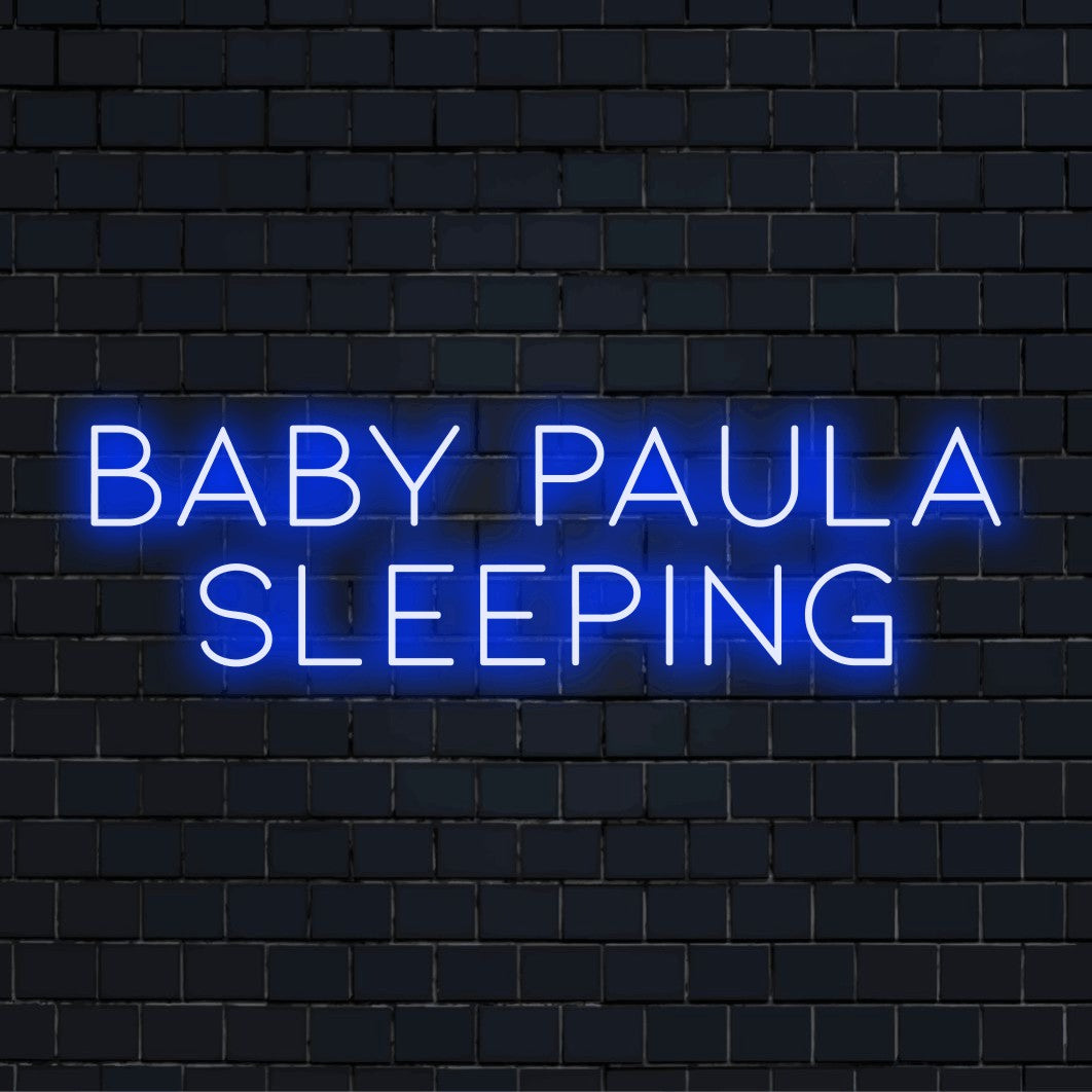 Baby Paula Sleeping Personalized LED Neon Sign, glowing neon text on dark brick background