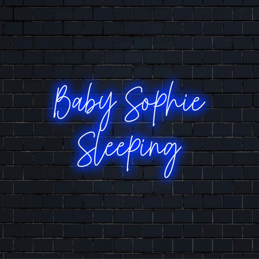 Baby Sophie Sleeping Custom Name Neon Sign, bright neon glow on black brick background