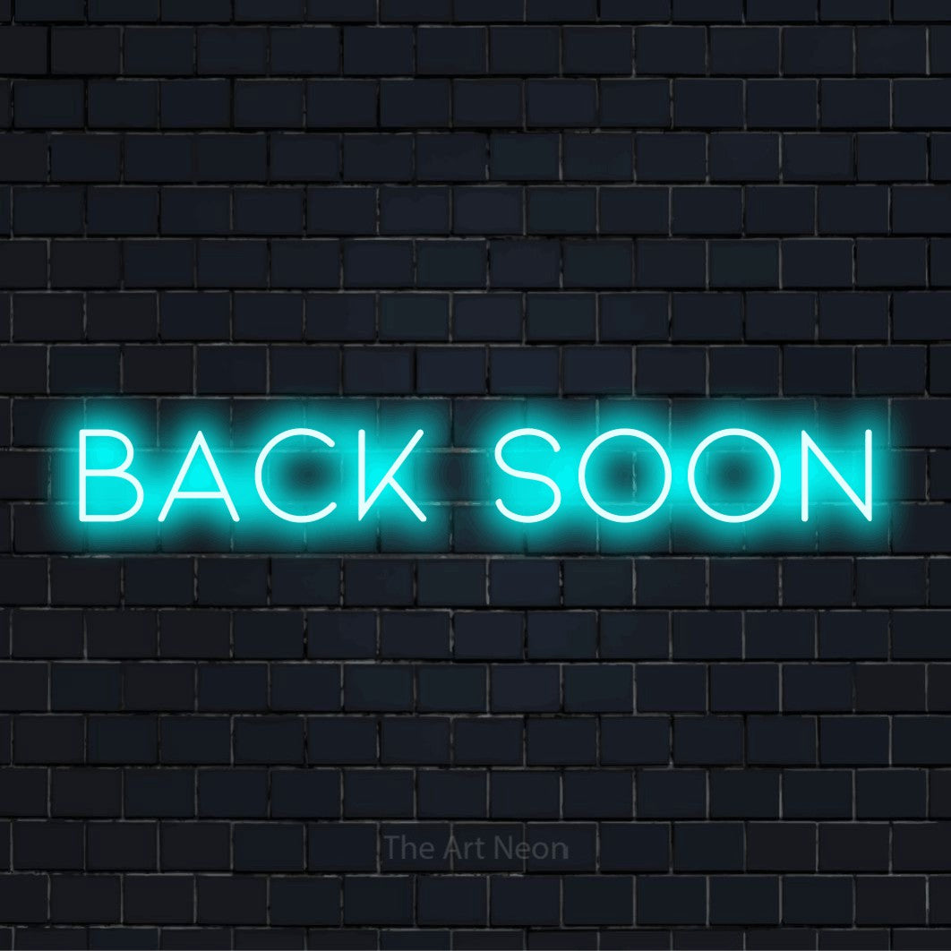 "Back Soon" LED neon sign on a black brick wall
