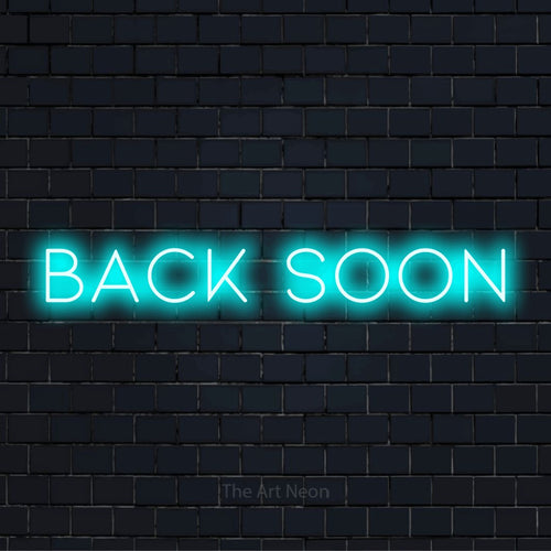 "Back Soon" LED neon sign on a black brick wall