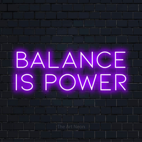 "Balance Is Power" text design with neon effect on a black brick wall