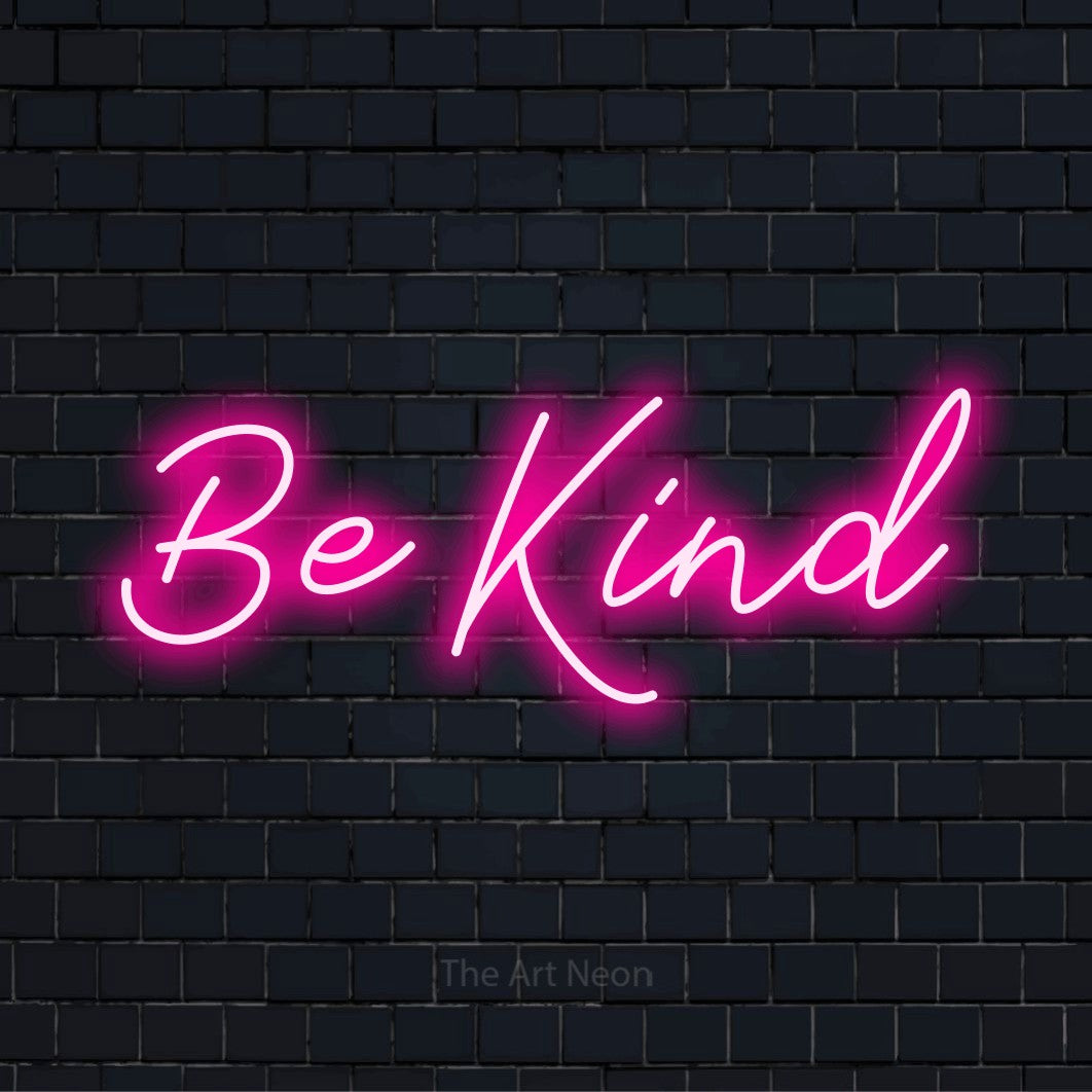 "Be Kind" script-style LED neon sign on a black brick wall