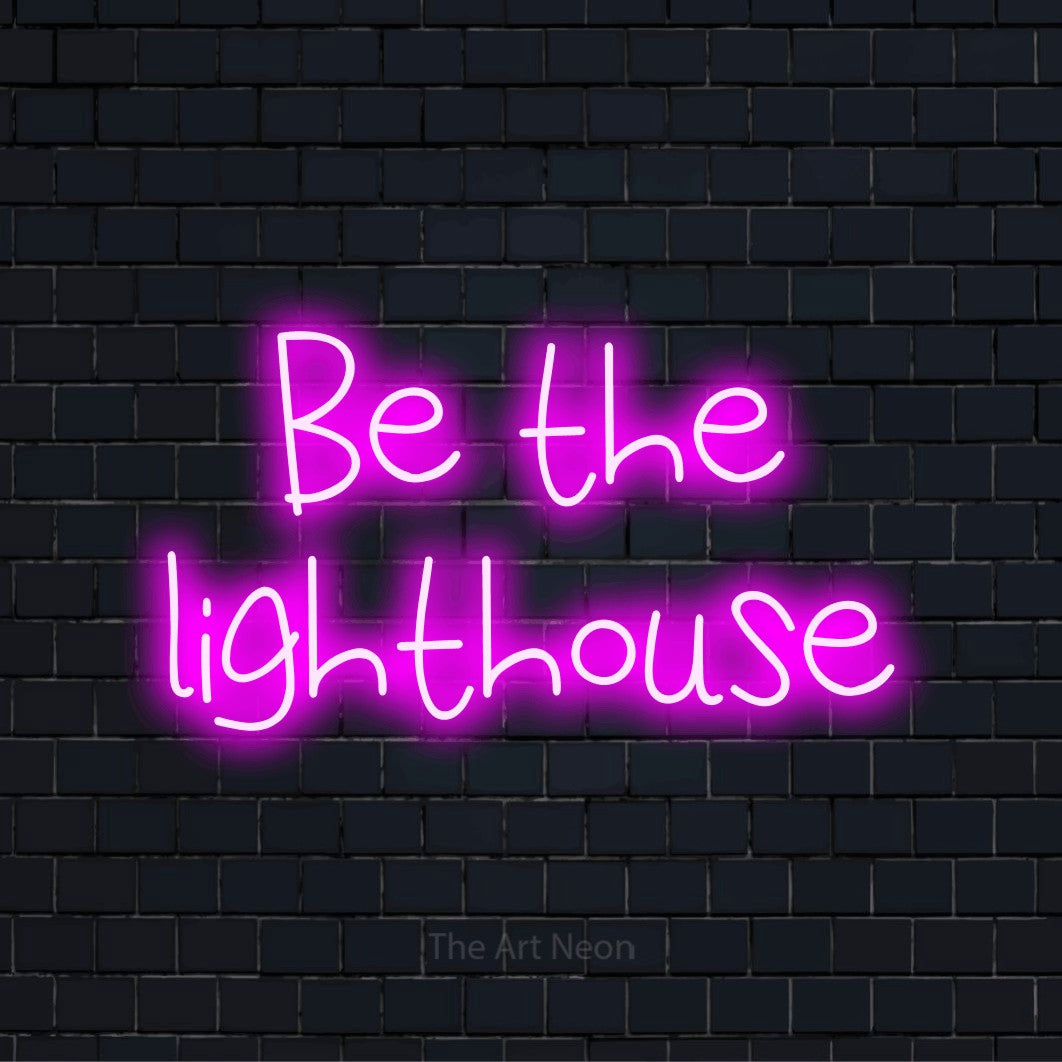 "Be The Lighthouse" script-style LED neon sign on a black brick wall