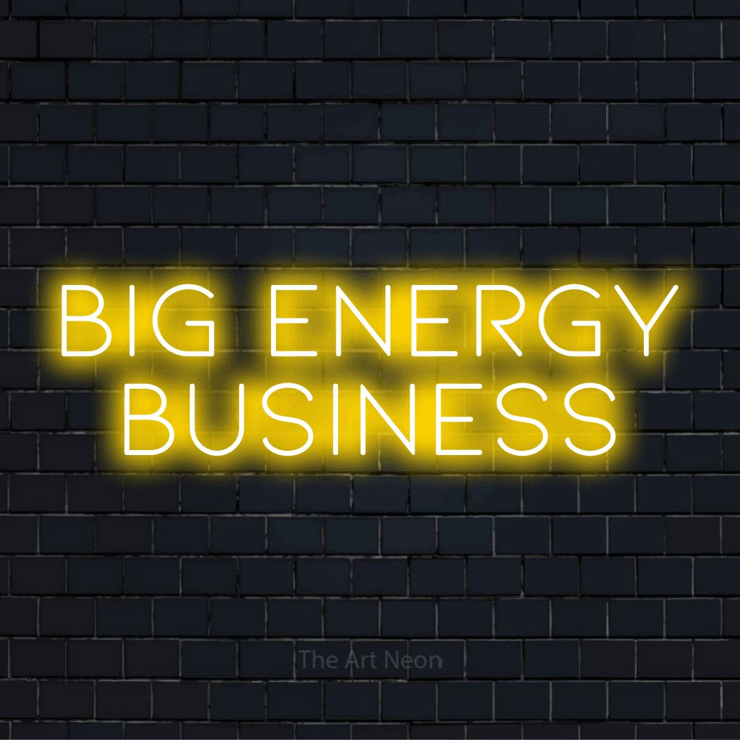 "Big Energy Business" script-style LED neon sign on a black brick wall