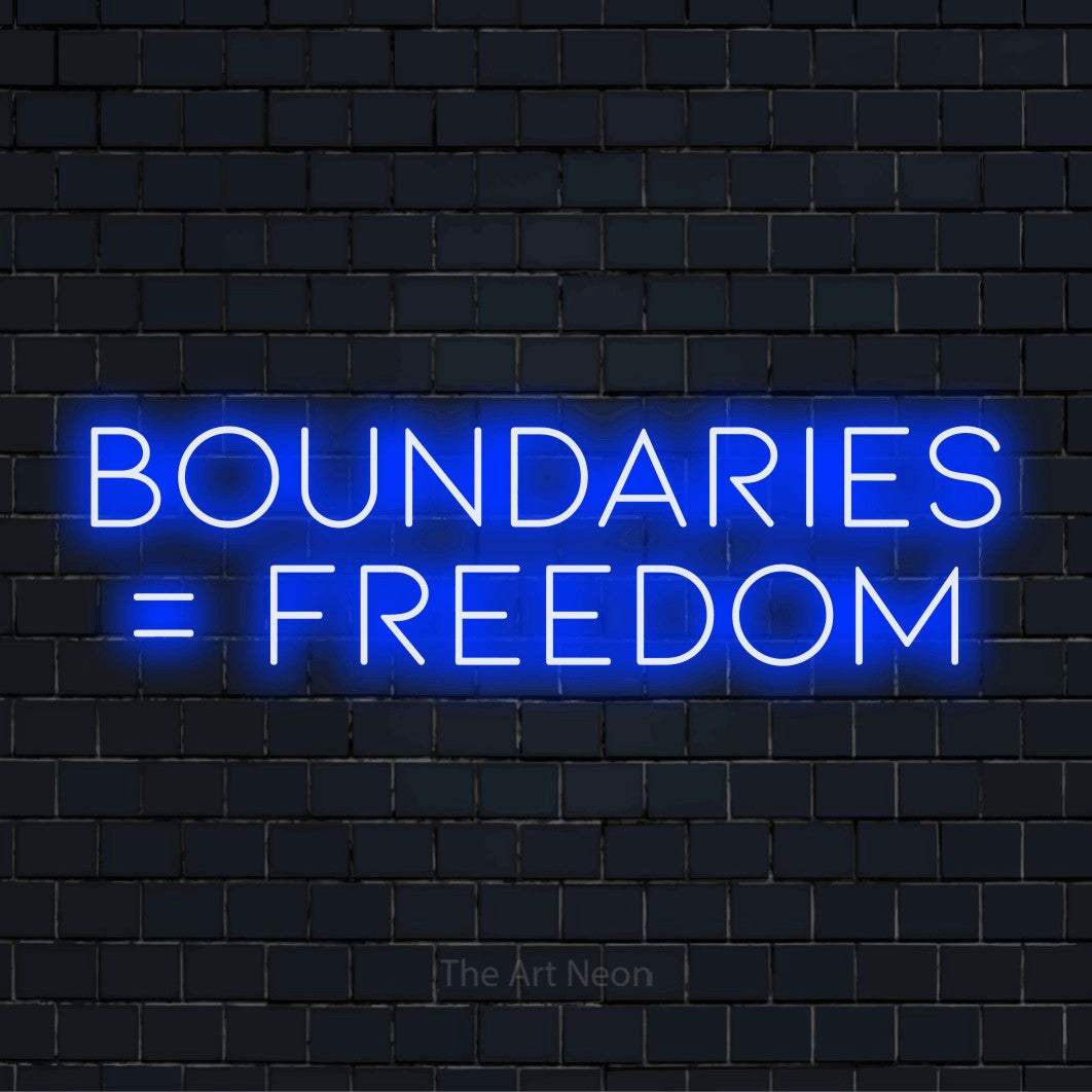 "Boundaries = Freedom" LED neon sign on a black brick wall