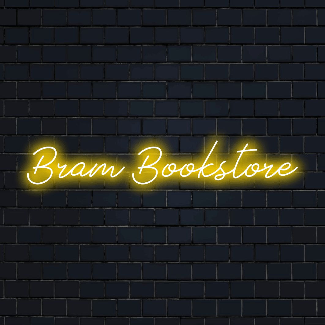 Bram Bookstore Personalized LED Neon Sign, soft neon glow on dark brick wall