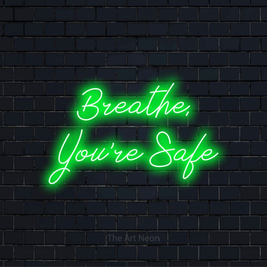 "Breathe, You’re Safe" text design with neon effect on a black brick wall
