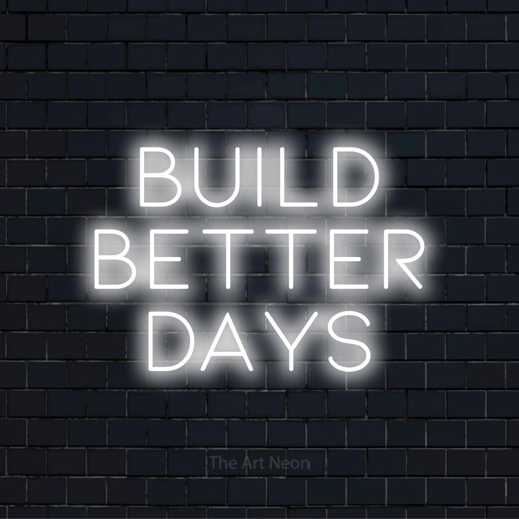 "Build Better Days" text design with neon effect on a black brick wall