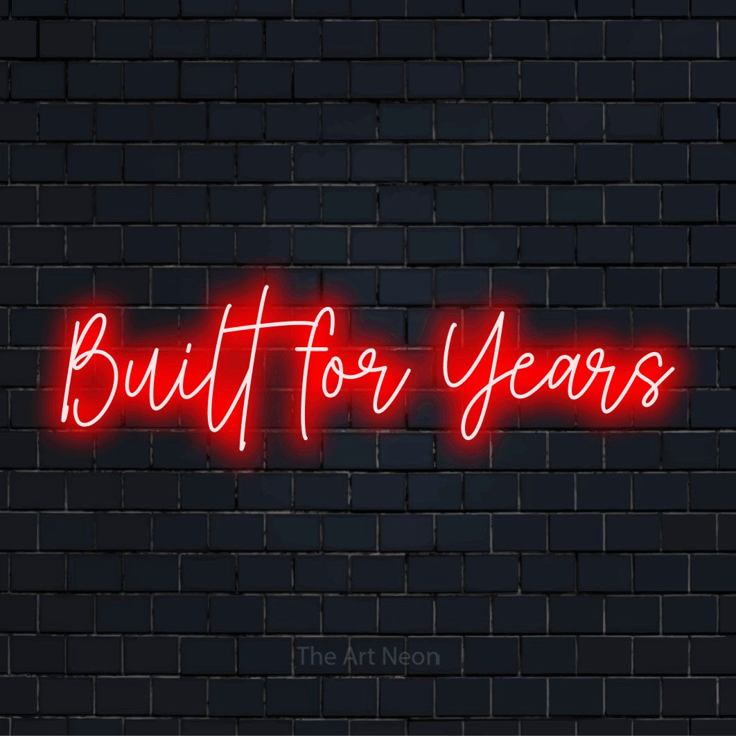 "Built For Years" neon text design on a black brick wall
