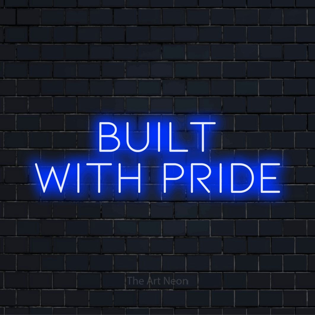 "Built With Pride" glowing LED neon sign on a black brick wall