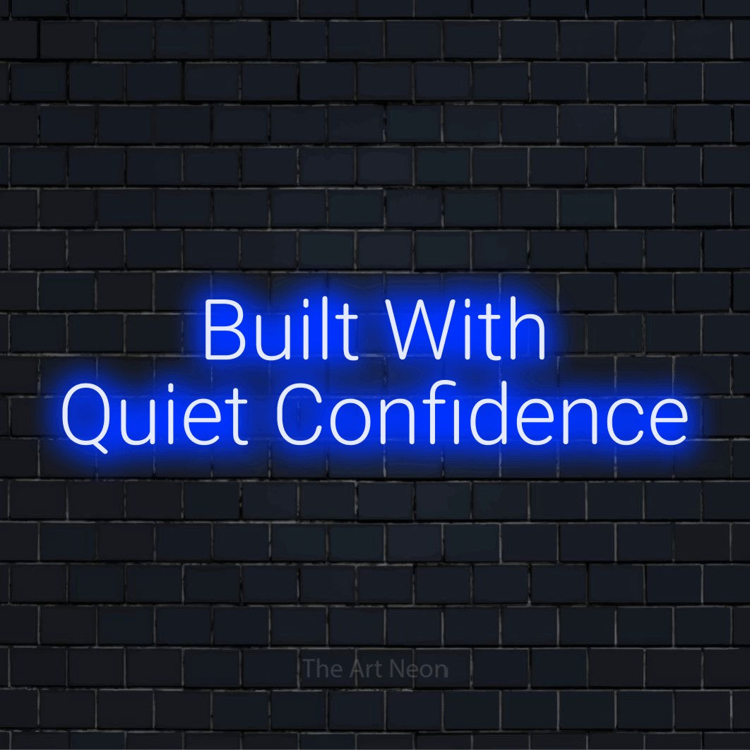 "Built With Quiet Confidence" glowing LED neon sign on a black brick wall