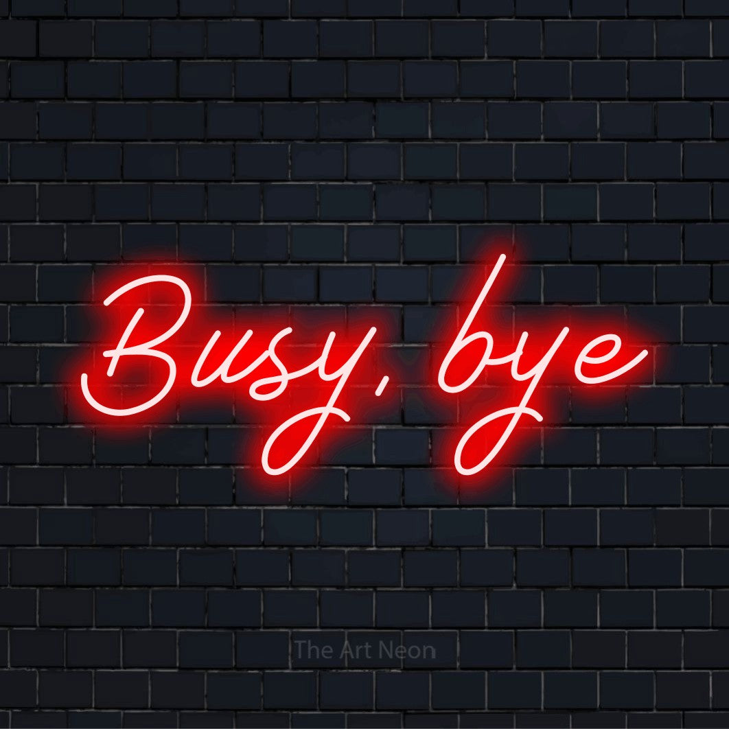 "Busy, Bye" script-style LED neon sign on a black brick wall