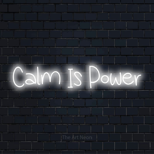 "Calm Is Power" text design with neon effect on a black brick wall