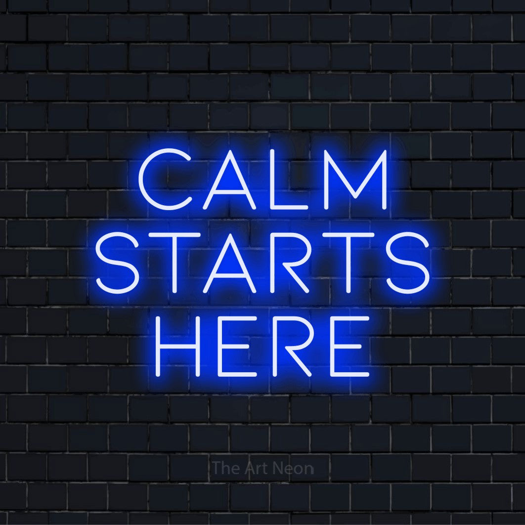 "Calm Starts Here" LED neon sign on a black brick wall