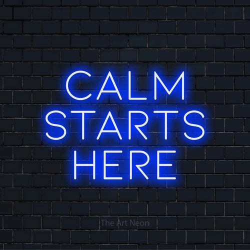 "Calm Starts Here" LED neon sign on a black brick wall