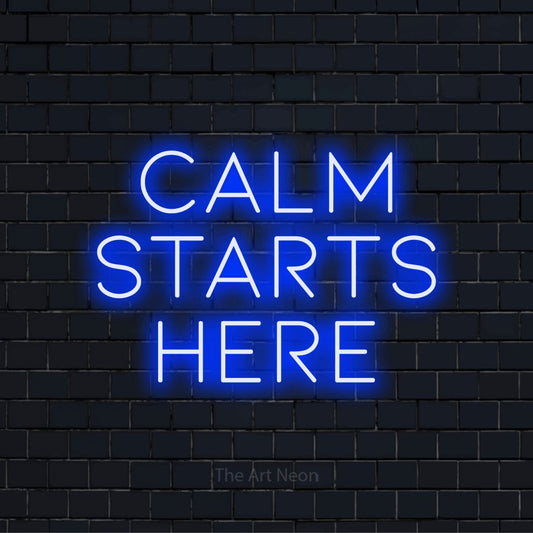 "Calm Starts Here" LED neon sign on a black brick wall