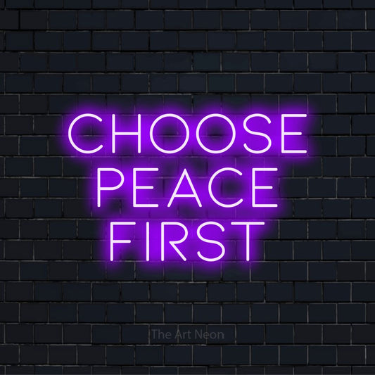 "Choose Peace First" neon text design on a black brick wall