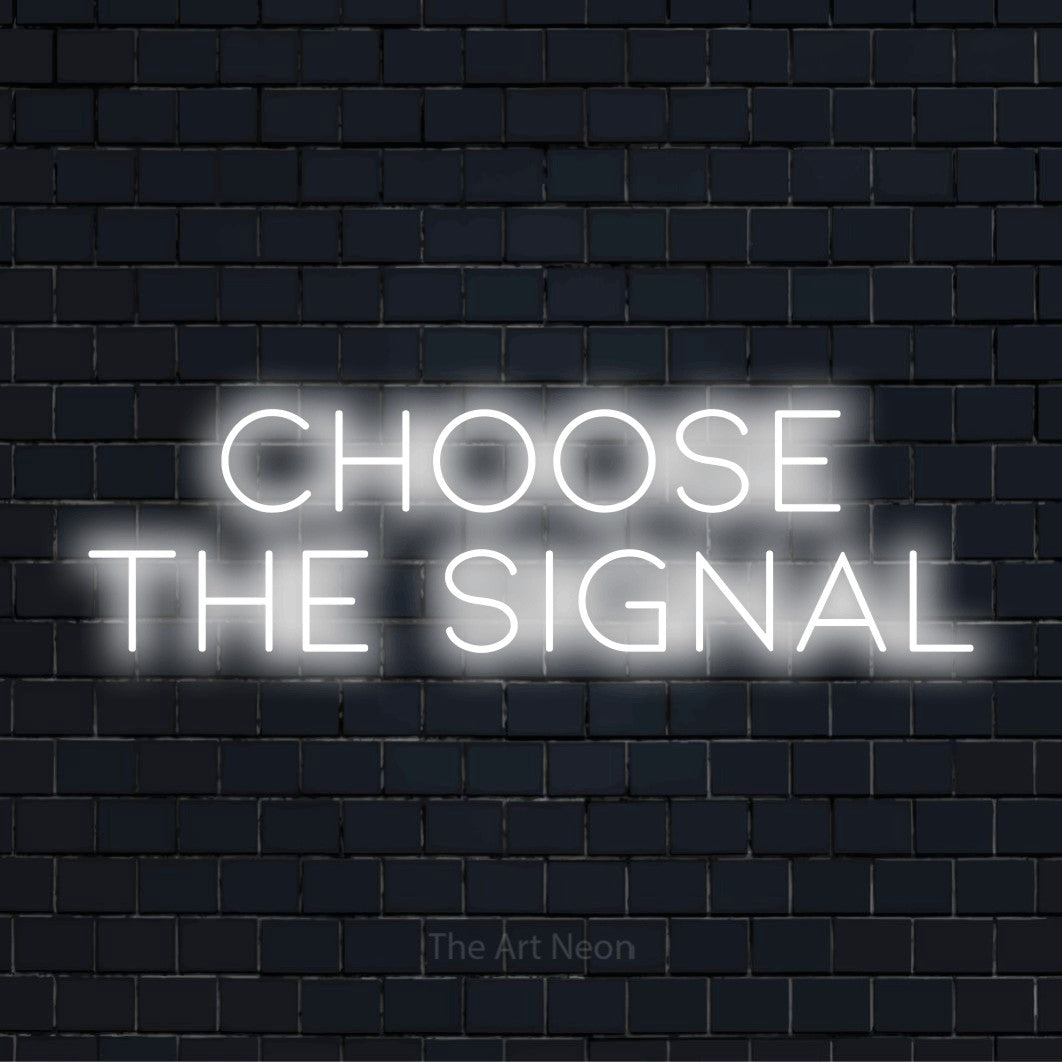"Choose The Signal" script-style LED neon sign on a black brick wall
