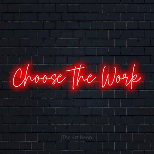 "Choose The Work" glowing LED neon sign on a black brick wall