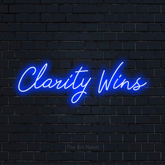 "Clarity Wins" LED neon sign on a black brick wall