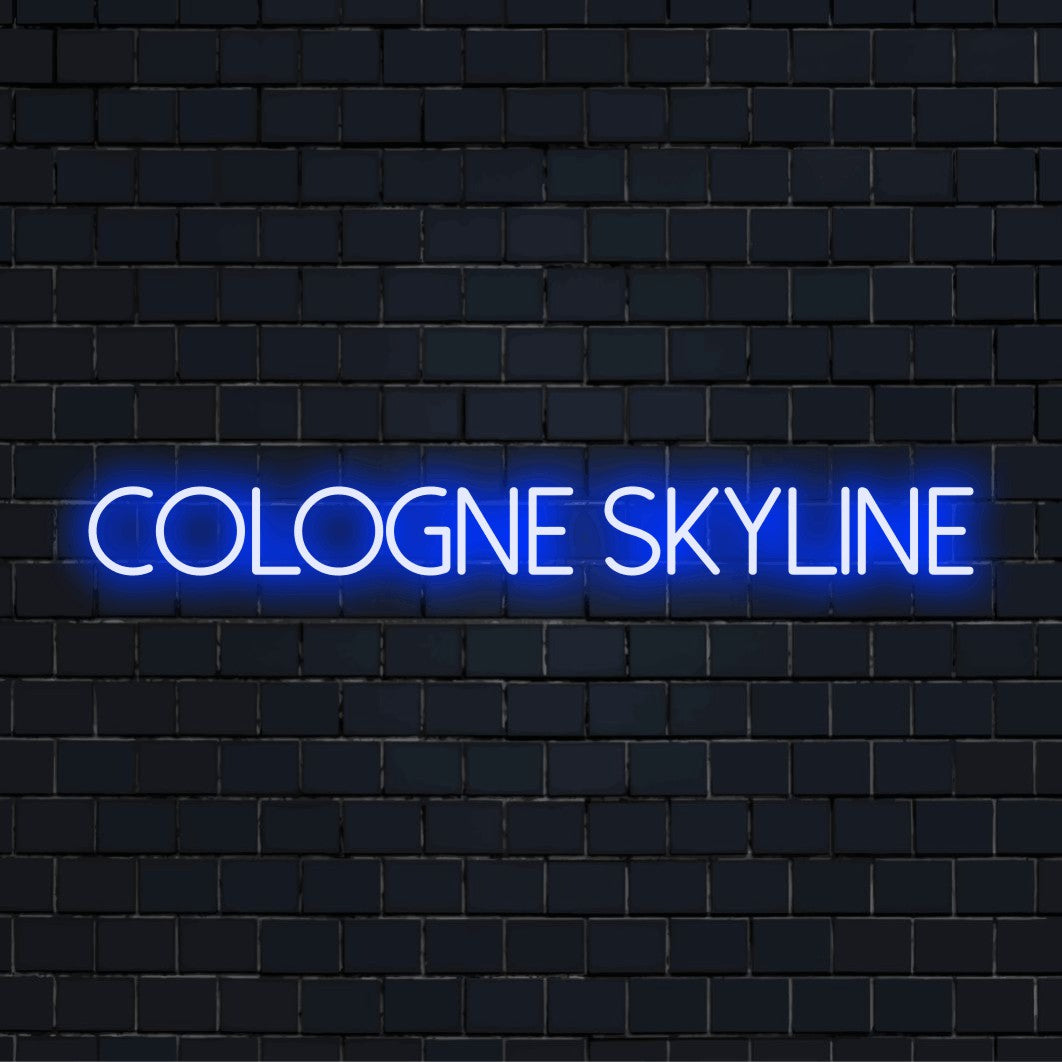 Cologne Skyline Neon Light with soft neon glow against brick backdrop