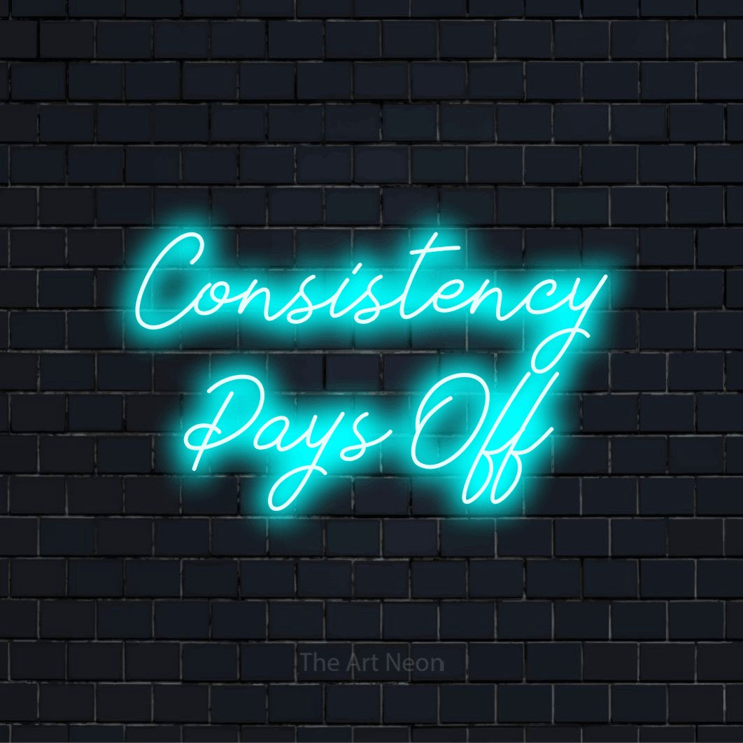 "Consistency Pays Off" neon text design on a black brick wall