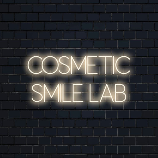 Cosmetic Smile Lab Neon Light with bright neon lettering on dark brick background