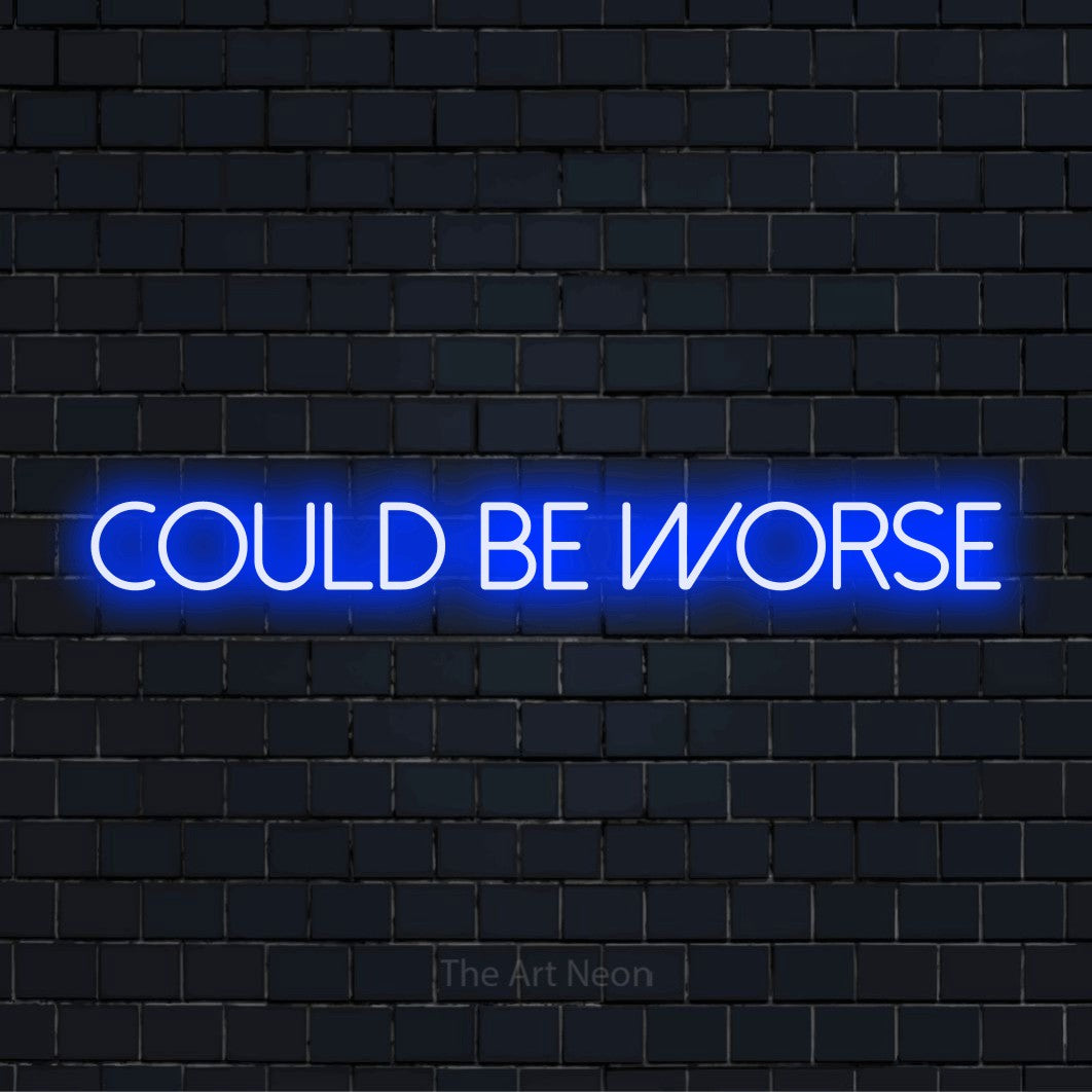 "Could Be Worse" LED neon sign on a black brick wall