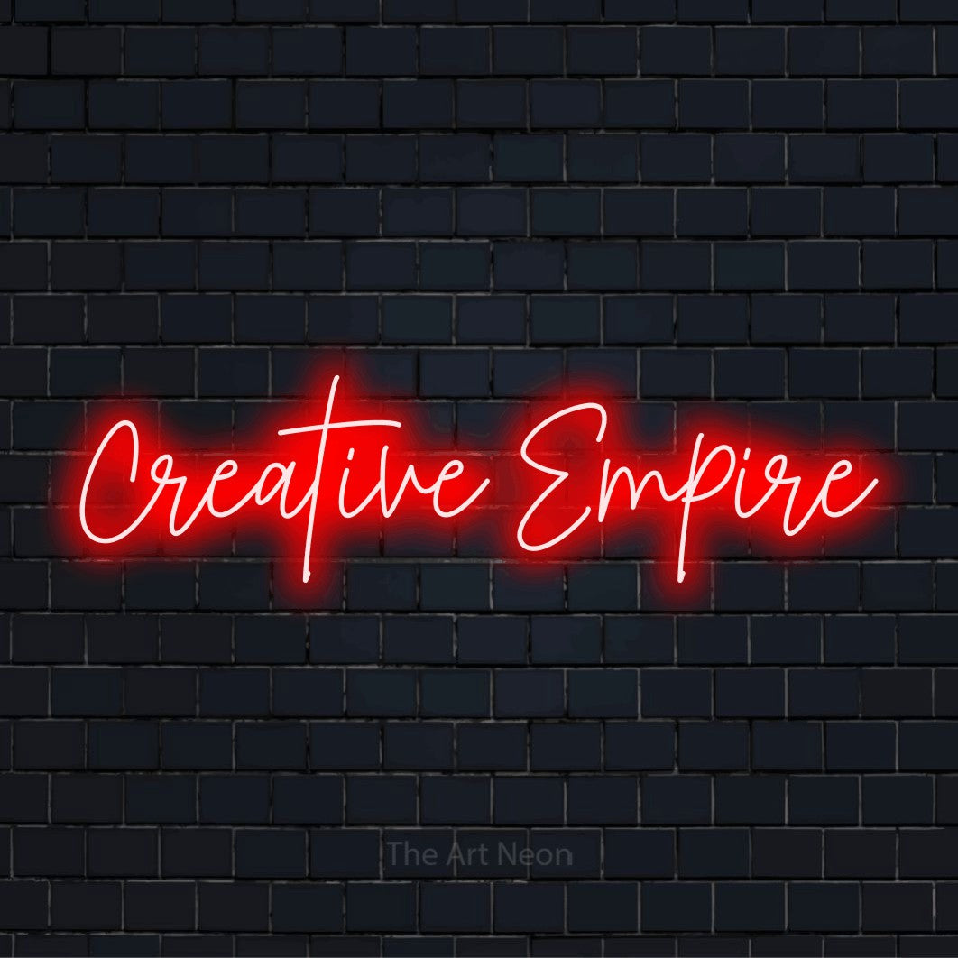 "Creative Empire" glowing LED neon sign on a black brick wall