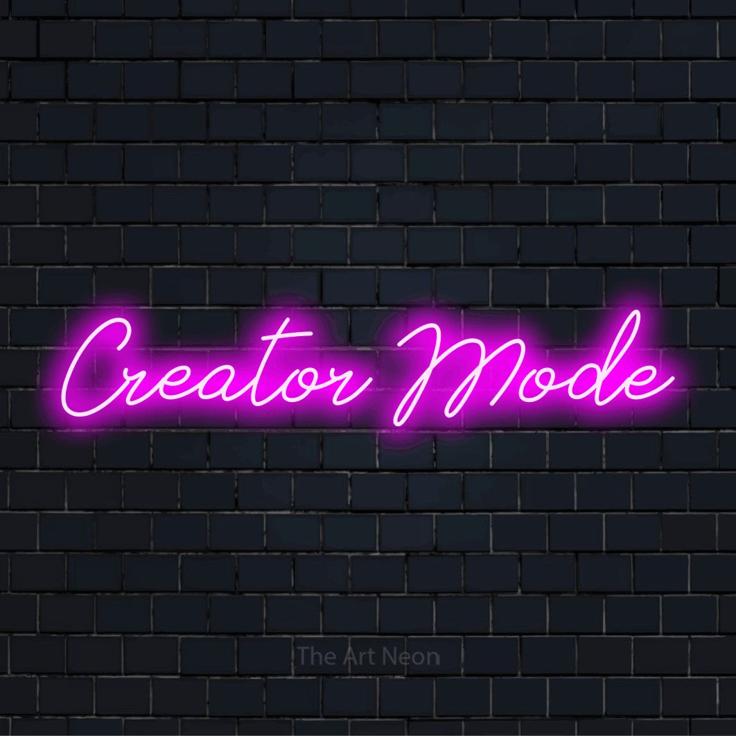 "Creator Mode" script-style LED neon sign on a black brick wall