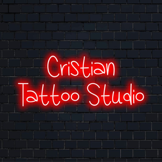 Cristian Tattoo Studio Custom Name Neon Sign, glowing wall decor against black brick wall