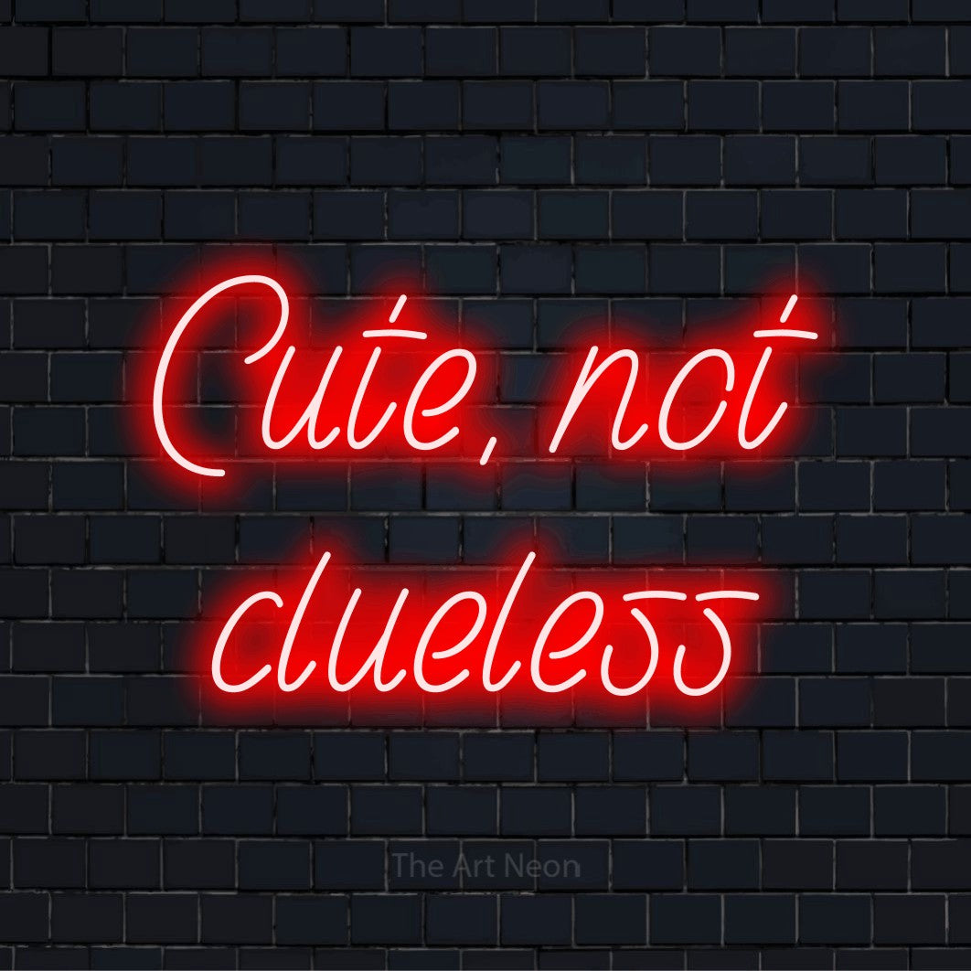 "Cute, Not Clueless" LED neon sign on a black brick wall