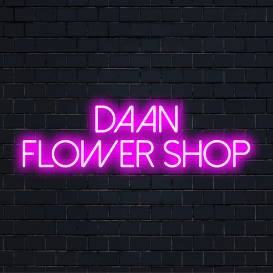 Daan Flower Shop Personalized LED Neon Sign, glowing lettering on dark brick background