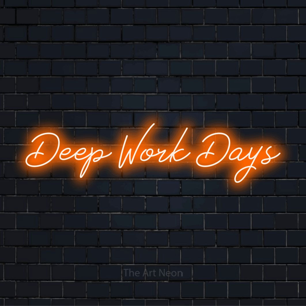 "Deep Work Days" glowing LED neon sign on a black brick wall