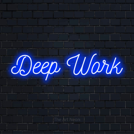 "Deep Work" glowing LED neon sign on a black brick wall