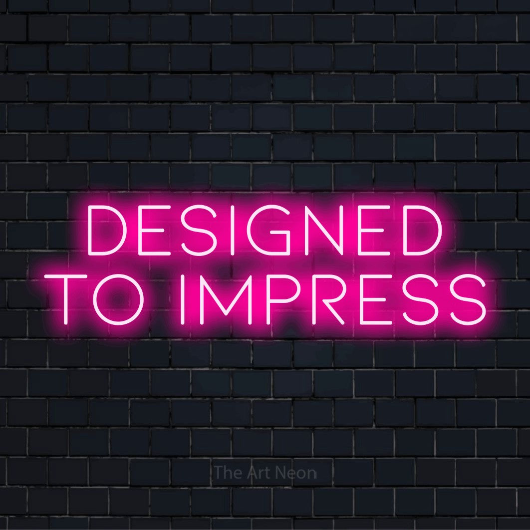 "Designed To Impress" neon text design on a black brick wall