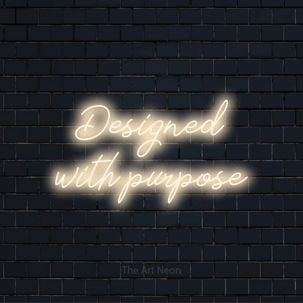 "Designed With Purpose" text design with neon effect on a black brick wall