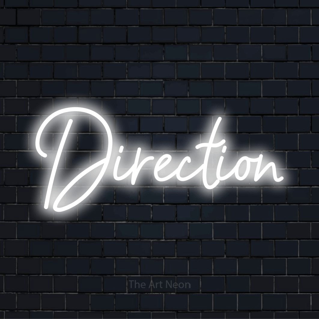 "Direction" LED neon sign on a black brick wall