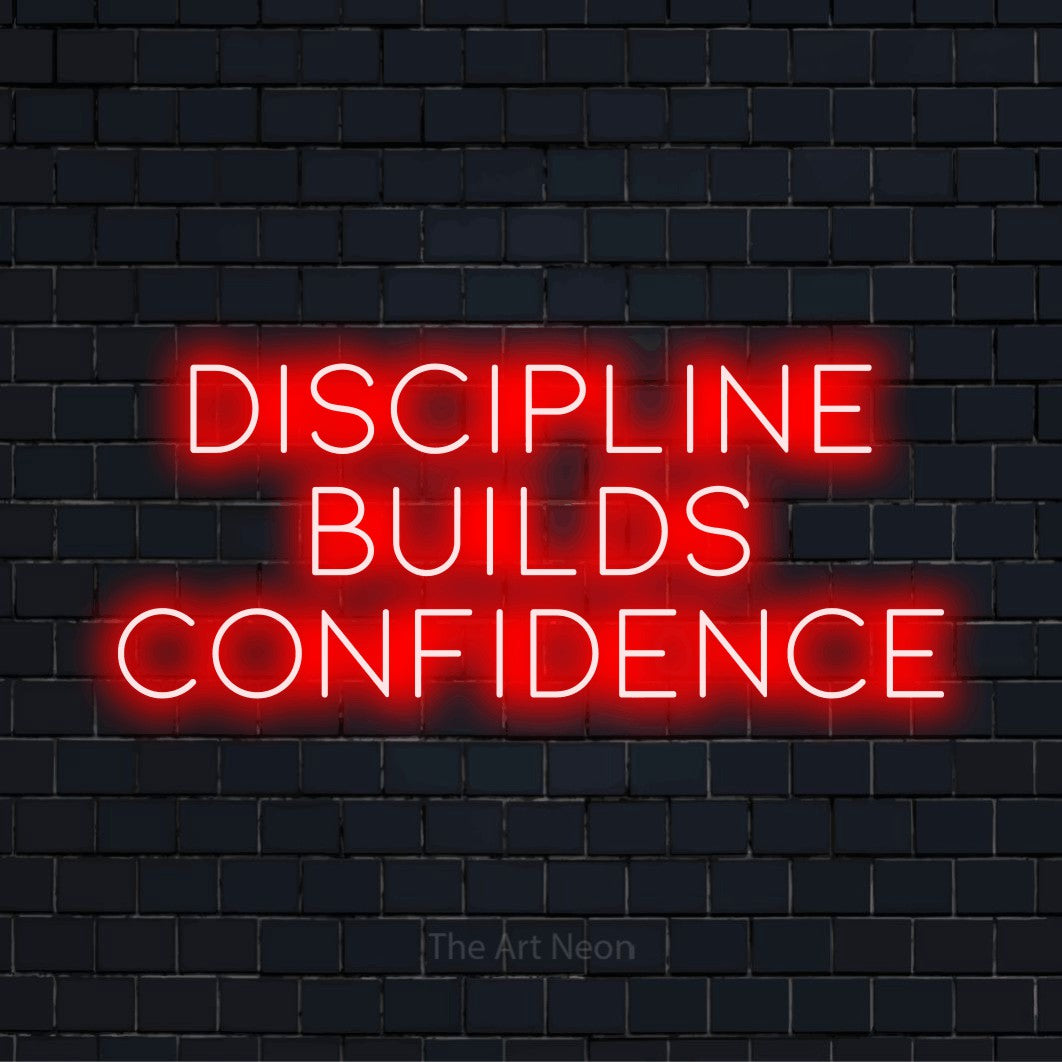 "Discipline Builds Confidence" glowing LED neon sign on a black brick wall