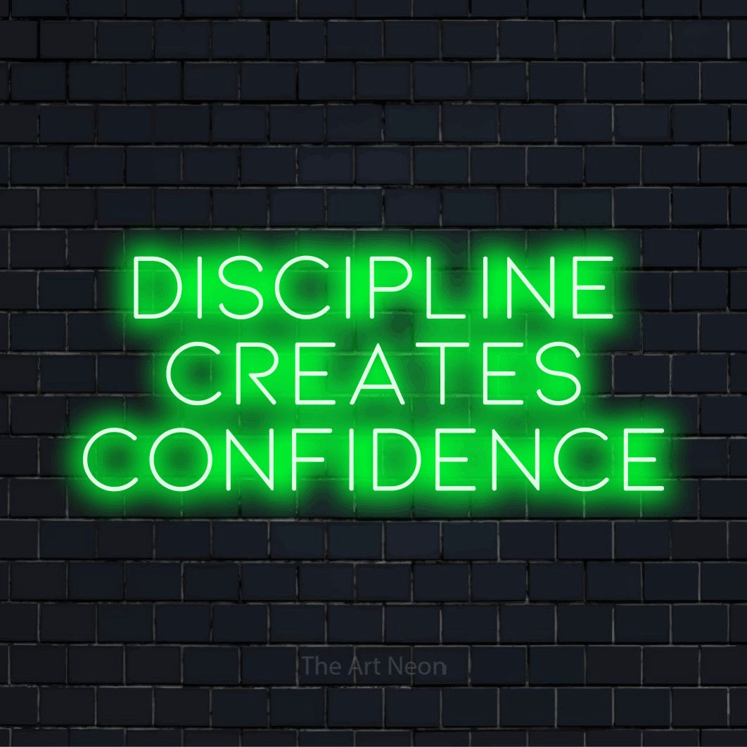 "Discipline Creates Confidence" LED neon sign on a black brick wall