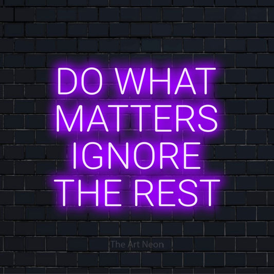 "Do What Matters Ignore The Rest" LED neon sign on a black brick wall