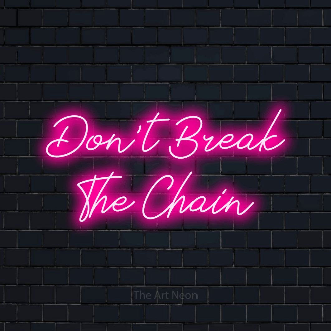 "Don’t Break The Chain" neon text design on a black brick wall