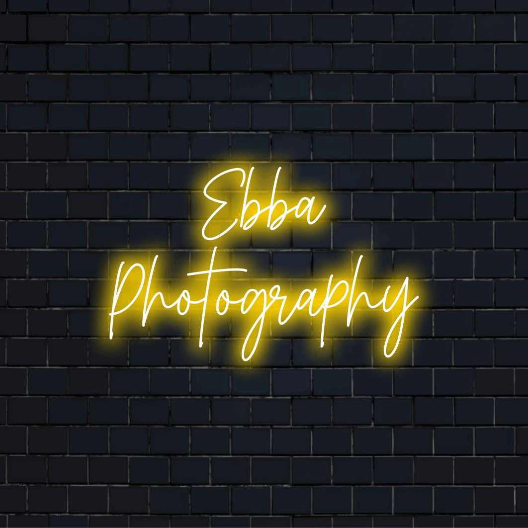 Ebba Photography Custom Name Neon Sign, bright LED glow on dark brick wall