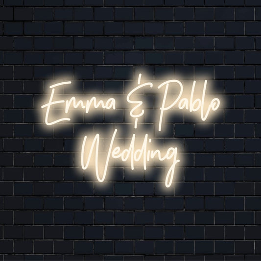 Emma _ Pablo Wedding Personalized Neon Light with glowing wall decor against black brick wall