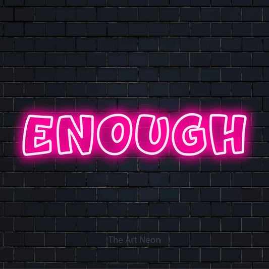 "Enough" glowing LED neon sign on a black brick wall