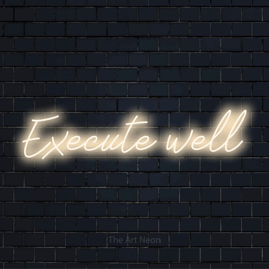 "Execute Well" LED neon sign on a black brick wall
