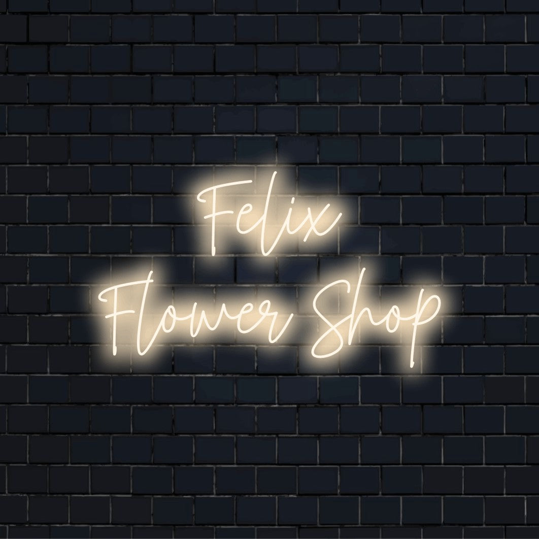 Felix Flower Shop Personalized LED Neon Sign, glowing neon text on black brick background