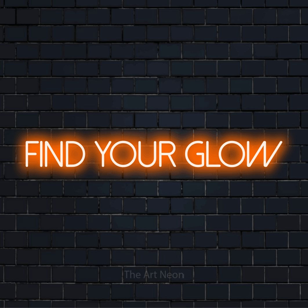 "Find Your Glow" neon text design on a black brick wall