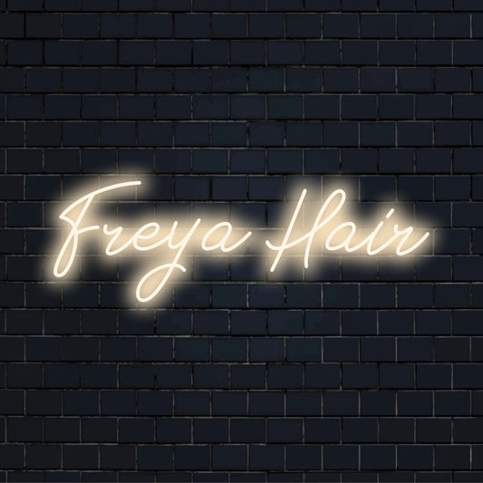 Freya Hair Custom Name Neon Sign, bright neon lettering against brick backdrop