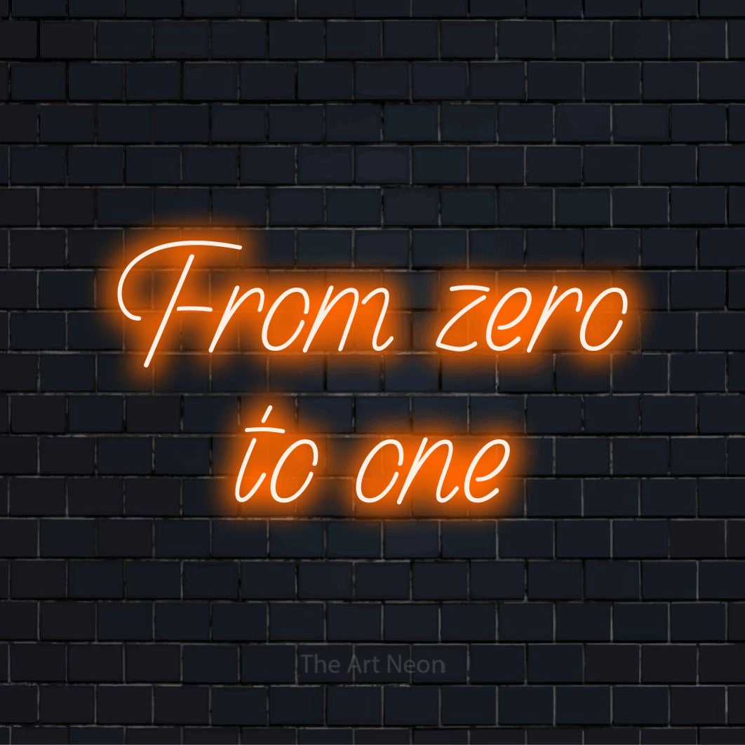 "From Zero To One" script-style LED neon sign on a black brick wall